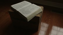 open Bible on a wooden box 