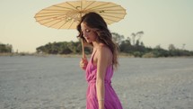 Girl Enjoy Summer On Beach with a chinese umbrella