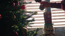 Nutcracker and Christmas tree over the Red Armchair