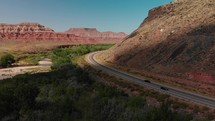 Drone flying over mountain landscape near Zion National Park with highway