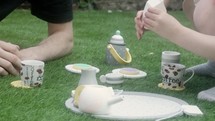 Father and daughter have tea party in the garden
