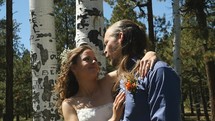 A happy young couple on their wedding day outdoors in the forest