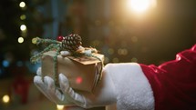 Hand Of Santa Claus Giving Christmas Present