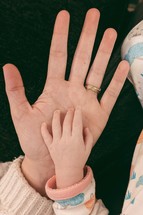 infant and father hand 