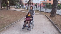 a man pushing a woman in a wheelchair 