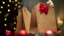 Christmas Gift Brown Bags Against Tree