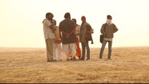 men standing in the desert coming into focus