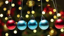 Christmas Balls Swinging Pendulum Against Tree
