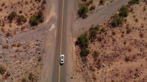 Drone is following car driving on historic route 66 through desert top shot
