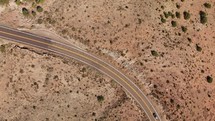 Drone circling above highway through desert