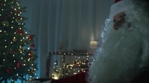 Santa Claus watching television in his house