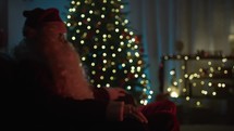 Santa Claus fighting the Christmas cold near a fireplace