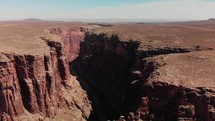 drone flying by canyon in desert