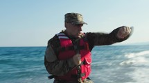 Military marine american man training boxe punch on the beach near ocean