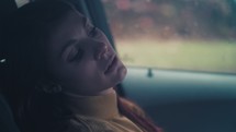 a sad woman alone in a car 