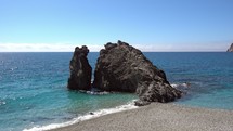 giant rock along a shore in Italy 