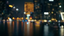 Blurred Illuminated City With Skyscraper In The Night 