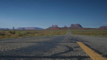Dolly across the road at scenic Monument Valley