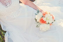 a bride holding a bouquet of flowers 