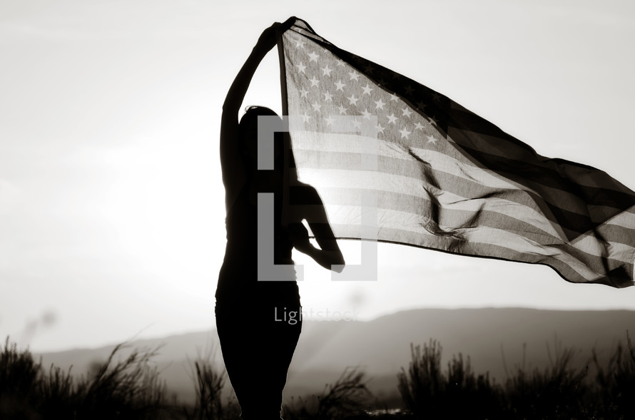 silhouette of a young woman with an American flag 