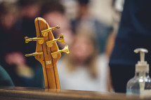 guitar leaning against a church pew 