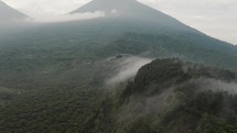 Misty Landscape With Lush Green Vegetation On Guatemalan Highlands - aerial drone shot	
