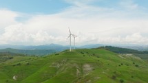 Wind power plant turbine generator on a green mountain