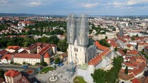 Aerial shot drone orbits to the left around Cathedral of Zagreb in Croatia