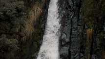Waterfall Plunging And Cascading Over Boulders In Cayambe Coca National Park, Papallacta, Ecuador - tilt down