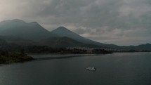Boat Sailing In Lake nearby Santiago Atitlan Sololá Guatemala - aerial shot	