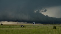 Powerful Storm Clouds Quickly Grow as Cars Pass by on a Busy US Highway.