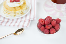 raspberries on pancakes and tea 