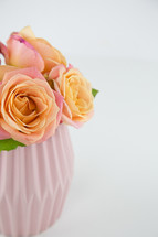 pink and peach roses in a vase 