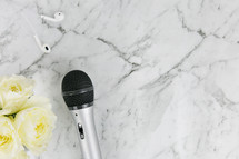 roses and microphone on marble background 