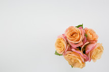pink and peach roses in a vase 