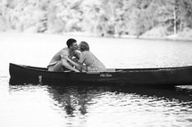 A couple kissing in a canoe
