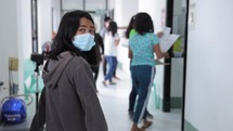 Asian Girl Walking Down Hospital Hallway