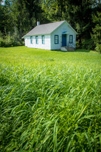 Rural quaint old community building with grassy yard 