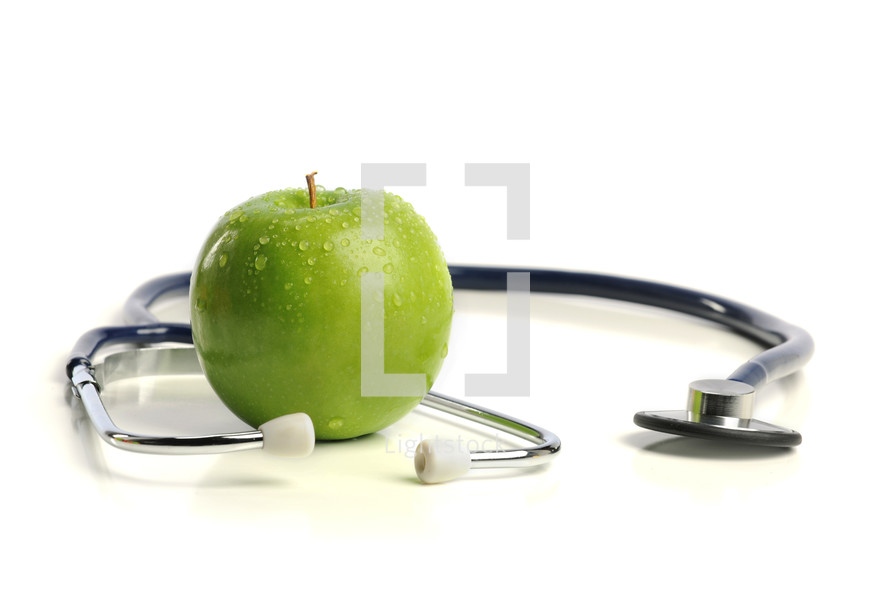 stethoscope and a green apple 