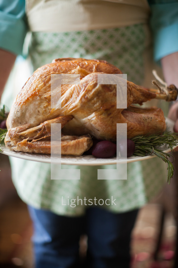 woman holding a Thanksgiving turkey 