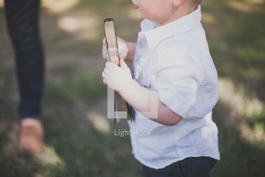 toddler boy holding a Bible