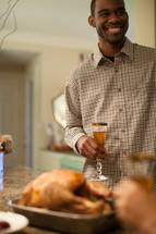 man toasting at a Thanksgiving table 