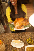 woman holding a Thanksgiving Turkey 