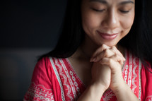 Asian woman with praying hands 