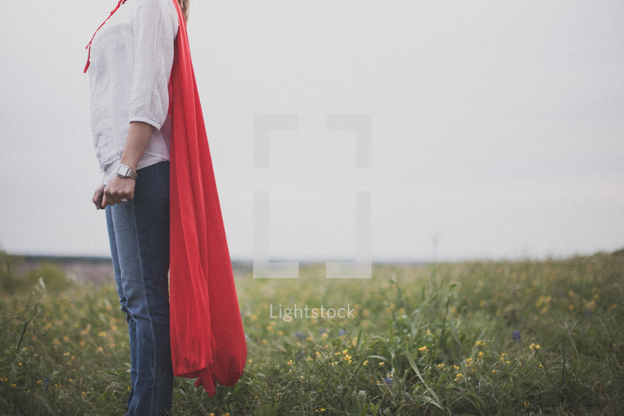 A super hero mom dressed in a red cape