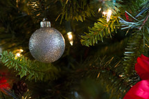 silver ornament on a decorated Christmas tree 