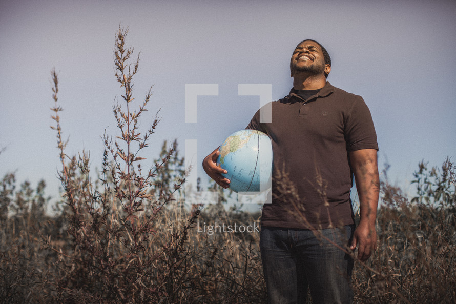 man holding a globe