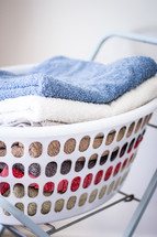 Stack of Towels in Washing Basket 