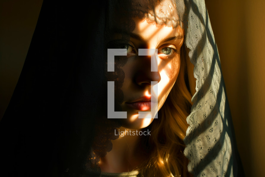 Portrait of a beautiful young woman in a veil in the rays of the sun