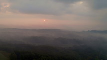 Aerial View of Sunrise and Heavy Fog in Mountains near Chattanooga, Tennessee. Moody morning scene with fog and sun.